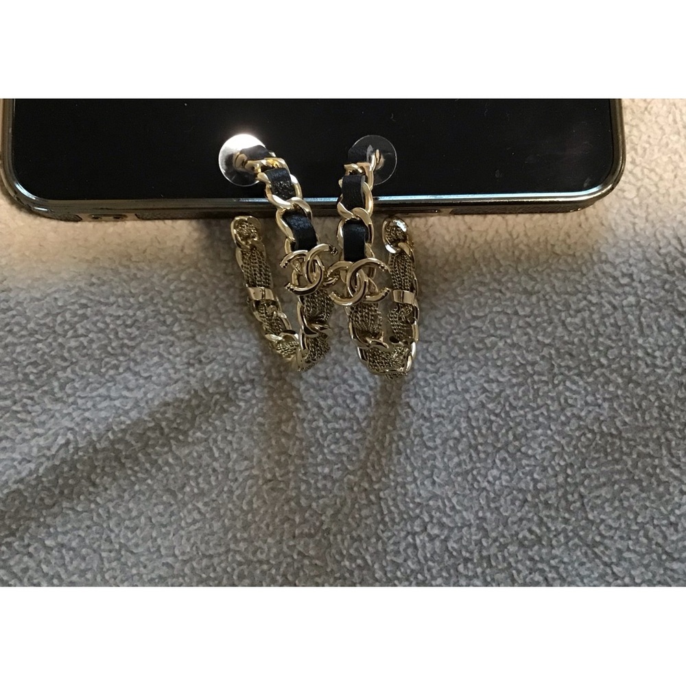 CHANEL black leather and gold earrings with chain detail